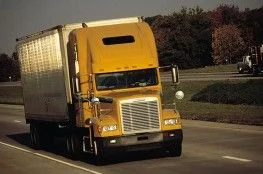 Yellow commercial truck on the highway